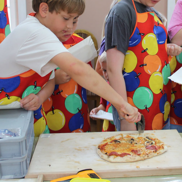 Pizza warsztaty kulinarne dzieci przyrządzają pizze